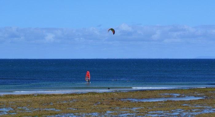 A wind surfer on a beach, Geelong. 2018