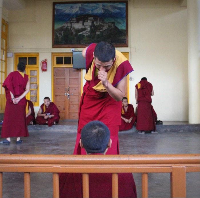 Tibetan monks practicing ritualized philosophical debate in Tsuklakhang monastery, Dharamsala. 2019